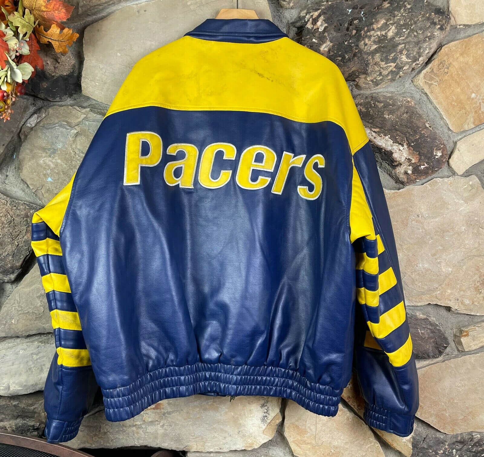 The worn, hand-painted black-over-Indiana Pacers-colored